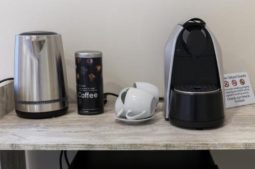 a counter with a coffee maker and a blender at Solar Mendonca in Faro