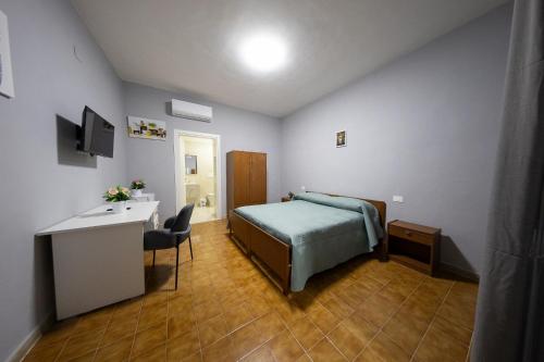 a hotel room with a bed and a desk and a desk at AFFITTACAMERE al CASTELLO AIROLA BN in Airola