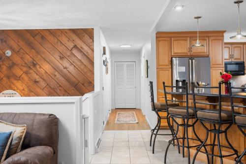 a kitchen and living room with wood paneling at Private & Convenient-Hot tub-Fire Pit-Game room! in Petoskey