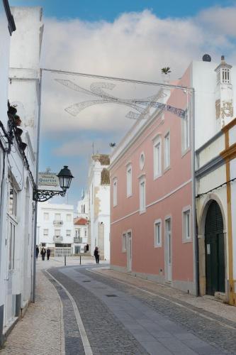 an empty street in a town with buildings at Solar Mendonca in Faro