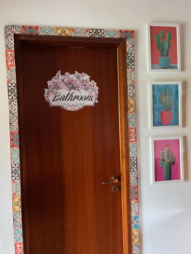 a wooden door with a sign on top of it at Ambrazzurra Apartament in Aci Castello