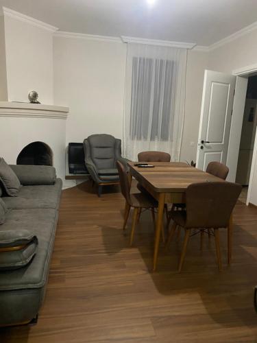 a living room with a table and a couch at Zurkas’ guesthouse in Batumi