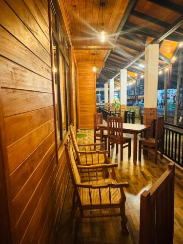 a restaurant with wooden walls and tables and chairs at sun mount adams peak in Adams Peak