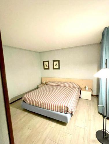 a bedroom with a bed with two pictures on the wall at Massarella Residence Universo in Pré-Saint-Didier
