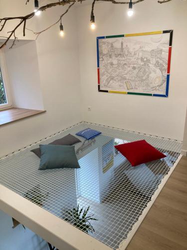 a room with a metal bed with pillows on it at 3 Chambres à louer chez habitant in Hambye