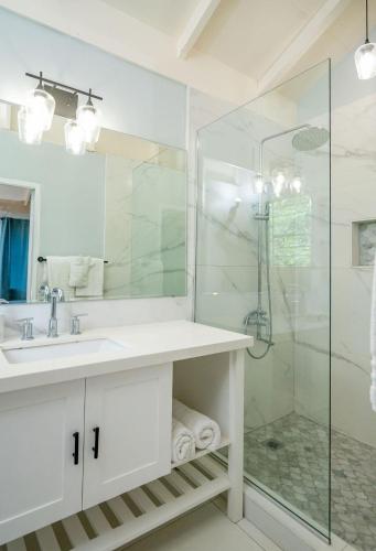 a white bathroom with a sink and a shower at Culloden Cove in Whitehouse