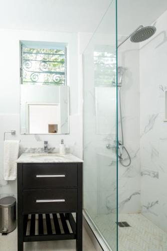 a bathroom with a sink and a glass shower at Culloden Cove in Whitehouse