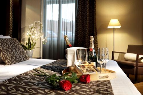 a hotel room with a tray of food and wine glasses at Eurostars Thalia in Prague