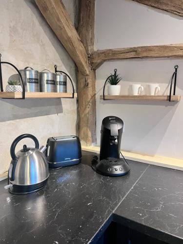 a kitchen counter with a tea kettle and a toaster at La tour de l Horloge, appt typique à 500m du château in Chinon