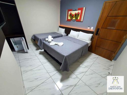 Postel nebo postele na pokoji v ubytování Hotel Portal dos Devotos
