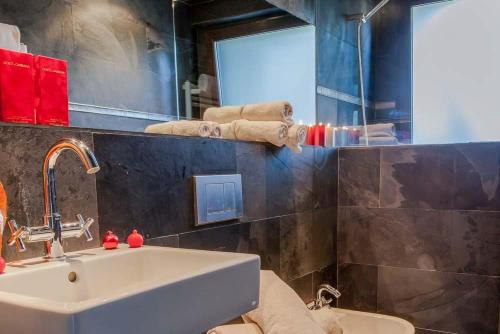 a bathroom with a sink and a toilet and a mirror at Villa Palmera in Olivella