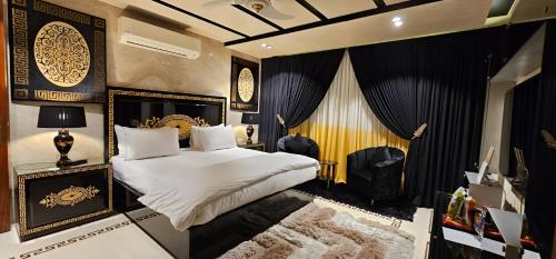 a bedroom with a bed and a television in it at Avenue-3 Guest House in Islamabad