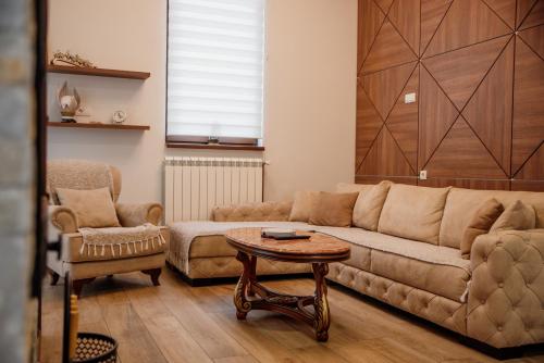 a living room with a couch and a table at Apartmani Jela Zlatar in Vukovina