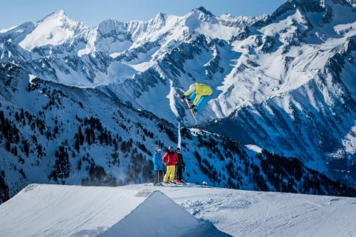 a person doing a trick on a snowboard on a mountain at Gasthof Residence Brugghof & Erlhof in Campo Tures