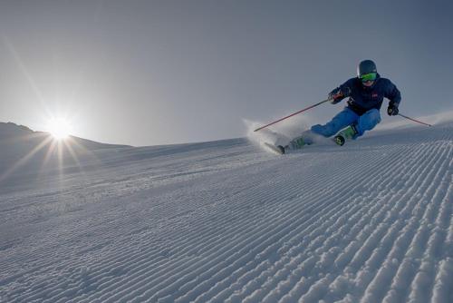 a person is skiing down a snow covered slope at Gasthof Residence Brugghof & Erlhof in Campo Tures