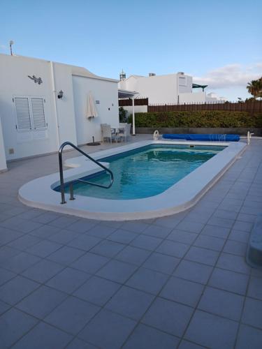 a swimming pool with a slide in a house at Casa Jaime in Puerto del Carmen