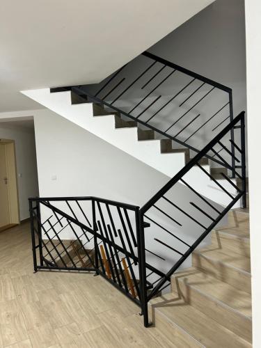 a black and white staircase in a house at Apartman Sneznik in Vrnjačka Banja