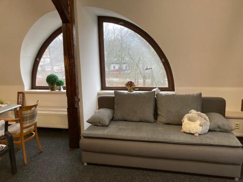 a living room with a couch with a stuffed animal on it at Apartmán Veleslavínova in Trutnov