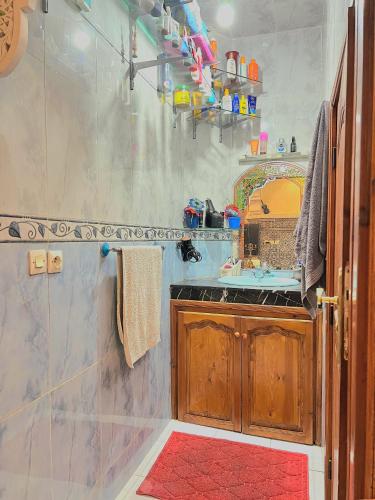 a bathroom with a shower with a sink and a mirror at cozy Apartment Near Airport in Marrakech