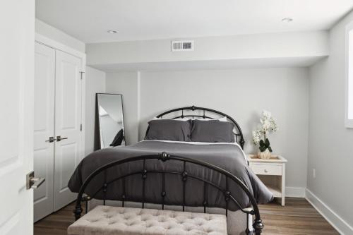 a bedroom with a black bed and a mirror at Luxury 4BR home 7 mins to US Capital, Rooftop deck, in Washington Free Parking in Washington, D.C.