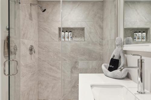a bathroom with a shower with a glass door at Luxury 4BR home 7 mins to US Capital, Rooftop deck, in Washington Free Parking in Washington, D.C.