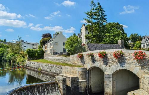 a stone bridge over a river with flowers on it at Amazing Home In Louargat With Wifi in Louargat