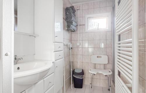a white bathroom with a sink and a toilet at Nice Chalet In Putten in Putten