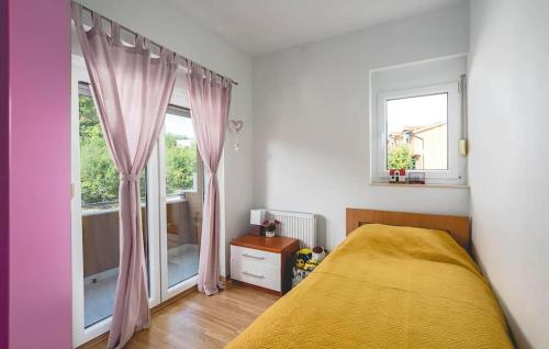 a bedroom with a bed with pink curtains and a window at Stunning Home In Trilj With Wifi in Trilj