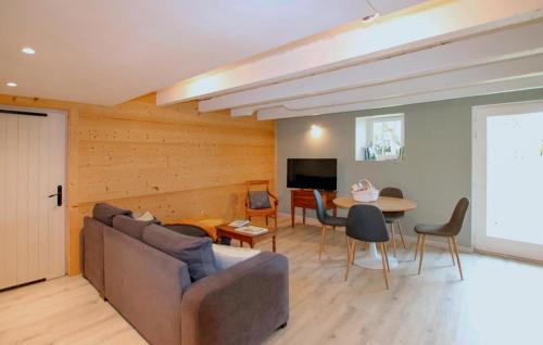 a living room with a couch and a table at 2 Bedroom Amazing Home In Cusy in Cusy