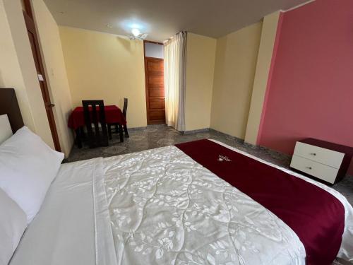 a bedroom with a bed and a table and a chair at HOTEL AREQUIPA in Nazca