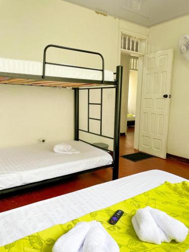 two bunk beds in a room with a door at Casa Condesa Hotel in Villeta