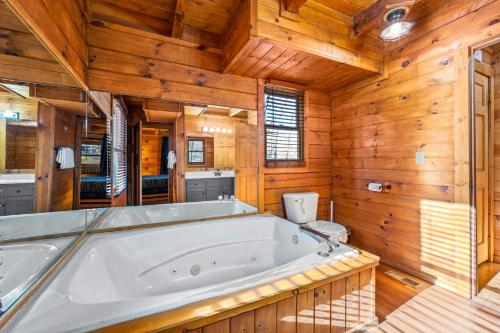 Habitación con bañera grande y paredes de madera. en Bearolina On My Mind, en Pigeon Forge