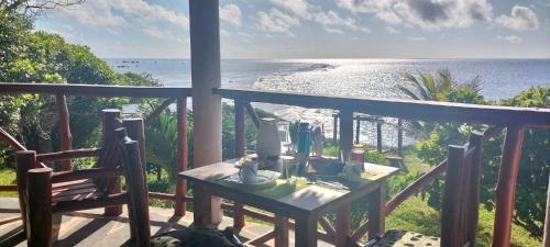 a balcony with a table and a view of the ocean at Eagle Suite 38m2 in Villa 560 m2, Indian Ocean View in Shimoni