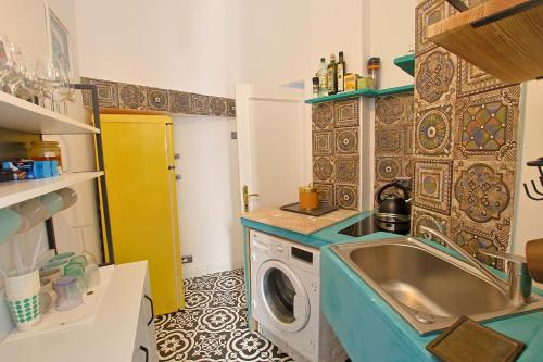 a kitchen with a sink and a washing machine at Art Boutique Residence in Bucharest