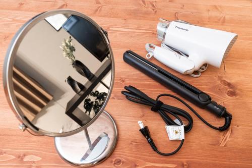 a mirror and a hair dryer on a wooden table at セントラルフィールド in Tokyo