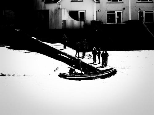a group of people standing on a boat in the snow at The Boathouse in Salcombe