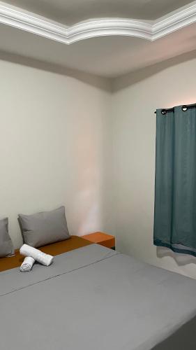 a bedroom with a bed with a blue curtain at Pousada Conviver in Juazeiro do Norte