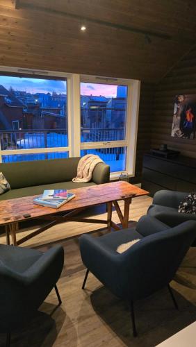 a living room with a couch and a table and chairs at Hemmingodden Lodge in Ballstad