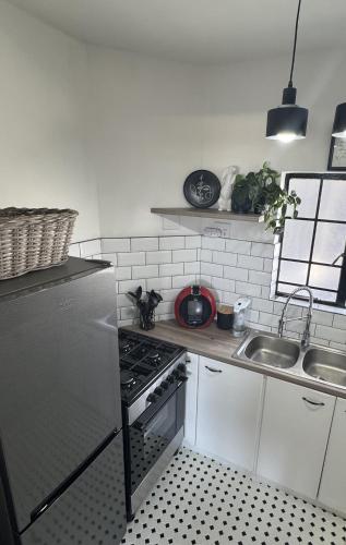 a kitchen with a stainless steel refrigerator and a sink at Beach Front Retreat in Fish Hoek in Fish hoek
