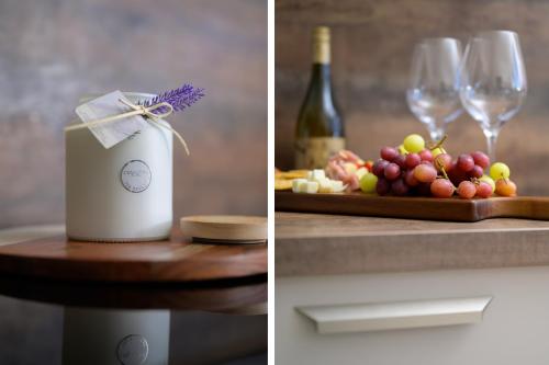 a table with wine glasses and a plate of grapes at Almara- Cosy cottage in fife in Fife