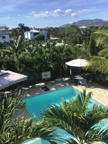 a view of the pool from the balcony of a resort at Villa Nilsa ( The Blue House ) in Baní