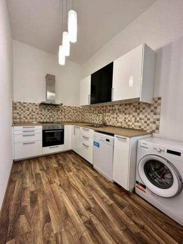 a kitchen with a washing machine and a washer at Michalska Residences in Bratislava
