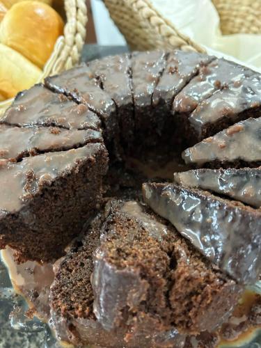 a chocolate cake with chocolate frosting on a plate at Pouso Trindade in Trindade