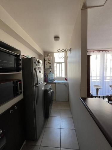 Kuchyň nebo kuchyňský kout v ubytování Acogedor departamento en La Serena