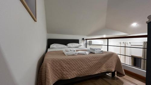 a bedroom with a bed with towels on it at Ρομαντικό Πέτρινο Διαμέρισμα για Ζευγάρια - Apt I in Chania Town