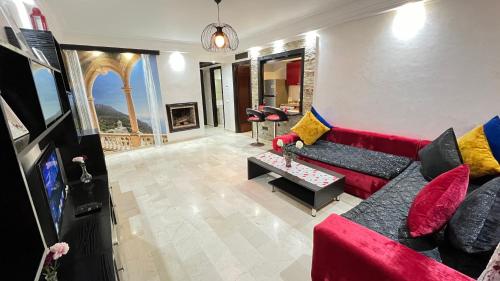 a living room with a red couch and a tv at Studio de luxe in Casablanca