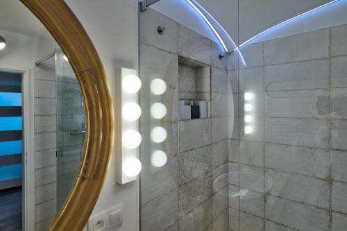 a bathroom with a shower with a mirror at House Big Win Mělník in Mlazice