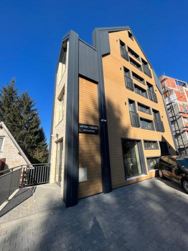 aartment building with a door in front of it at Winter House in Kopaonik