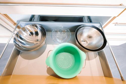 a shelf with various kitchen utensils and a fan at Le LOFT de la Route des Vins in Guebwiller
