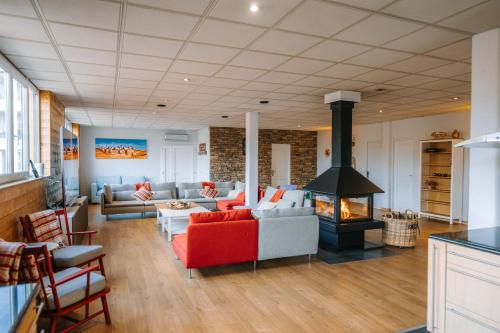 a living room with a couch and a fireplace at Le LOFT de la Route des Vins in Guebwiller
